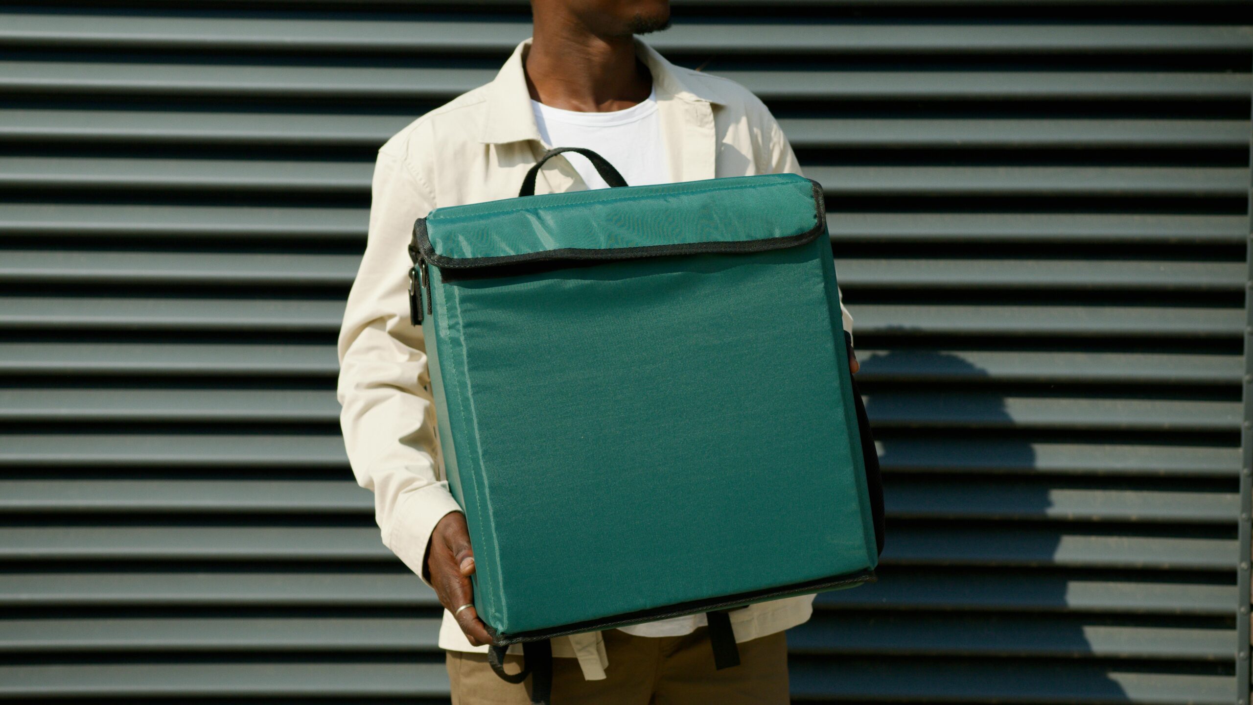 A person holding a green bag